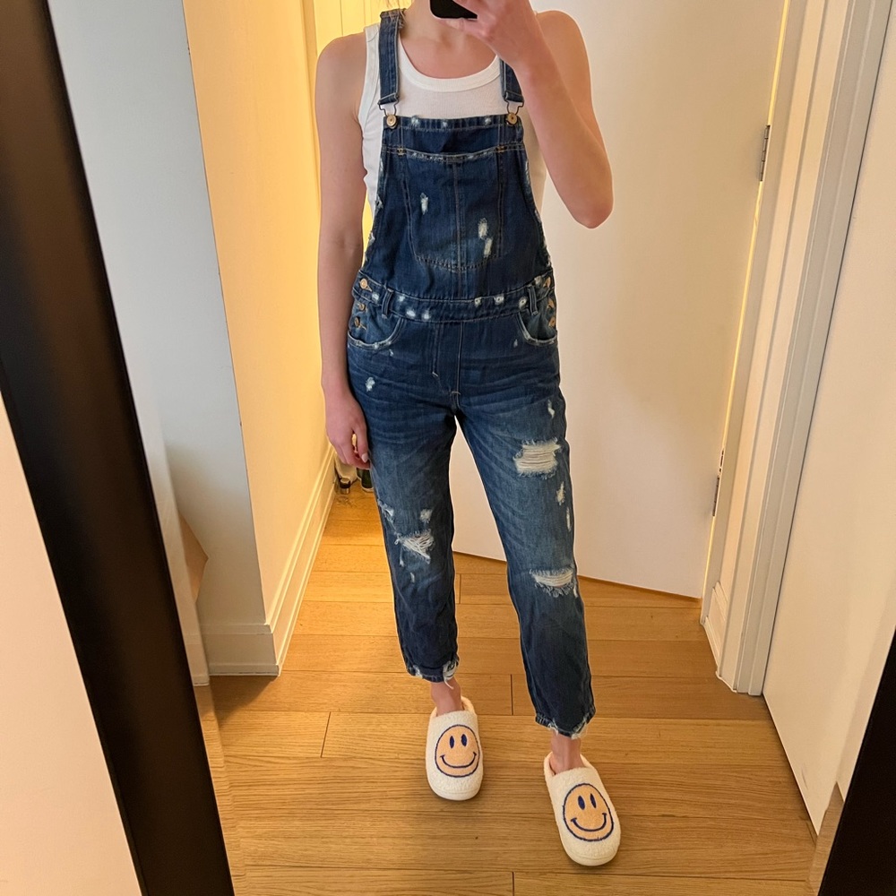 Distressed denim overalls